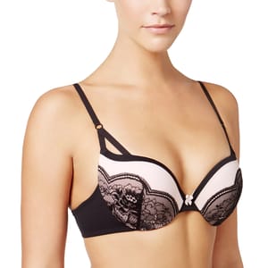 A woman is wearing a pink and black lace bra with thin adjustable straps. The design features floral lace detailing and a small bow in the center.