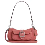 A pink suede shoulder bag with a detachable strap, buckle front pocket, and silver hardware, featuring a small tag.