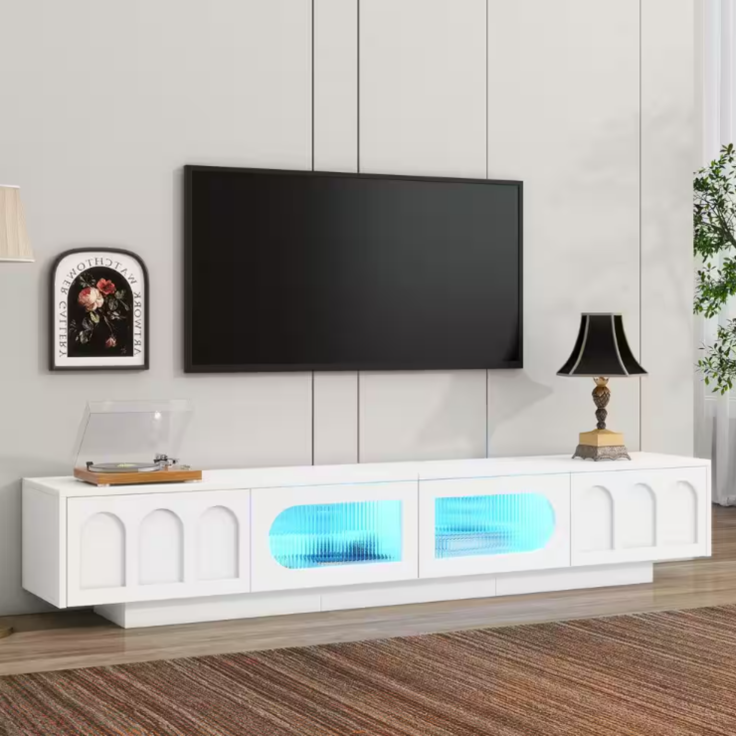 The Harper & Bright 87\“ Media Stand is a modern white TV stand featuring a sleek design with built-in LED lights, glass panel doors, and decorative arch accents, offering both style and functionality for living room entertainment setups.