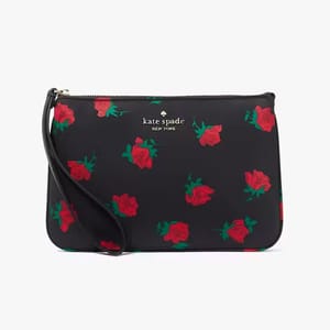 A black wristlet with red rose patterns and the \“kate spade new york\“ logo.