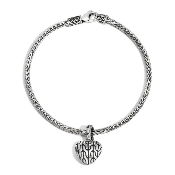 Silver chain bracelet with a heart-shaped charm featuring a black, wavy pattern. The design is sleek and elegant.