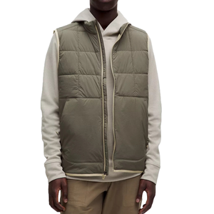 The lululemon Men's Insulated Vest is an olive green, quilted vest designed for warmth. It features a front zipper closure and two side pockets, making it suitable for layering over casual outfits.