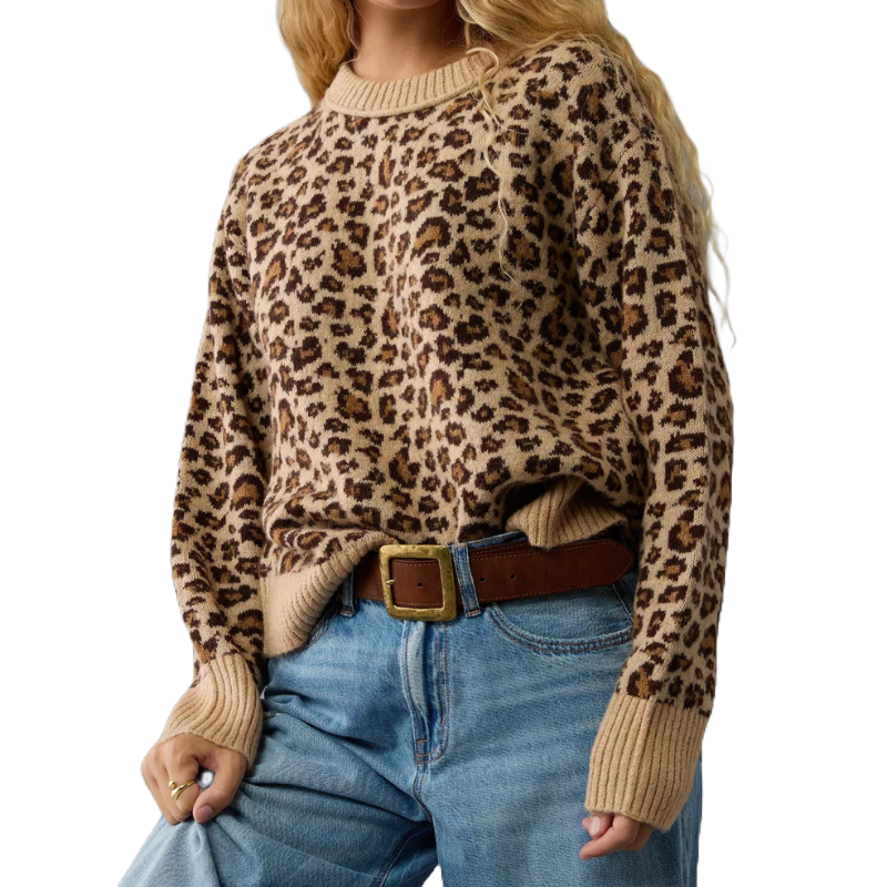 A soft crew neck sweater featuring a beige and brown leopard print pattern. It is styled with blue jeans and a brown belt.