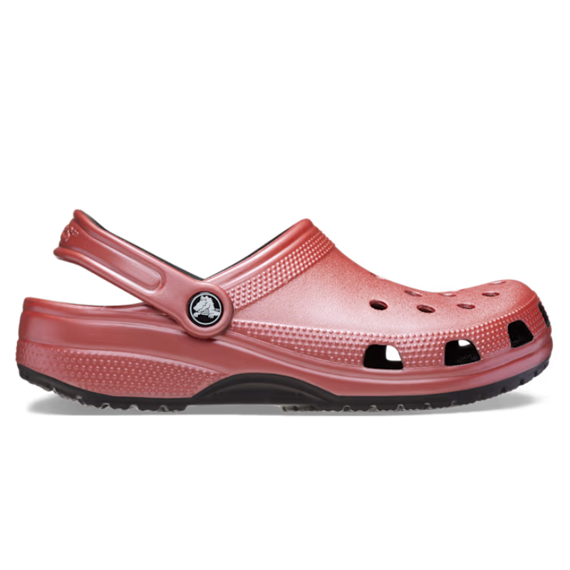 Metallic rose-colored Crocs Classic Clogs with a slip-on design, adjustable heel strap, ventilation holes on the top and sides, and a textured sole for grip.