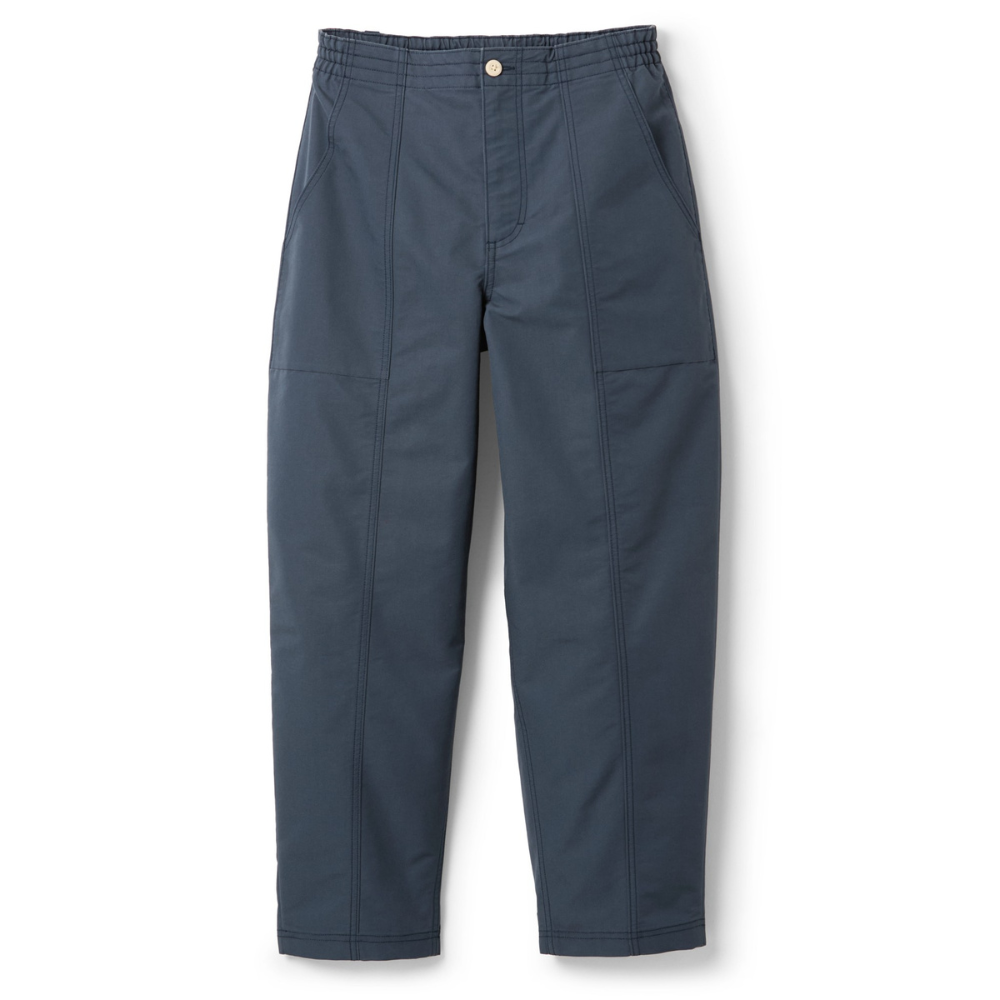 A pair of dark blue relaxed-fit pants with an elastic waistband, button closure, and side pockets, featuring prominent seam detailing.