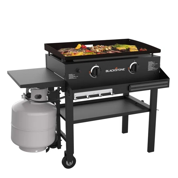 Outdoor Blackstone griddle with two burners, featuring cooked foods on top, a propane tank at the side, a side shelf, and wheels for mobility.