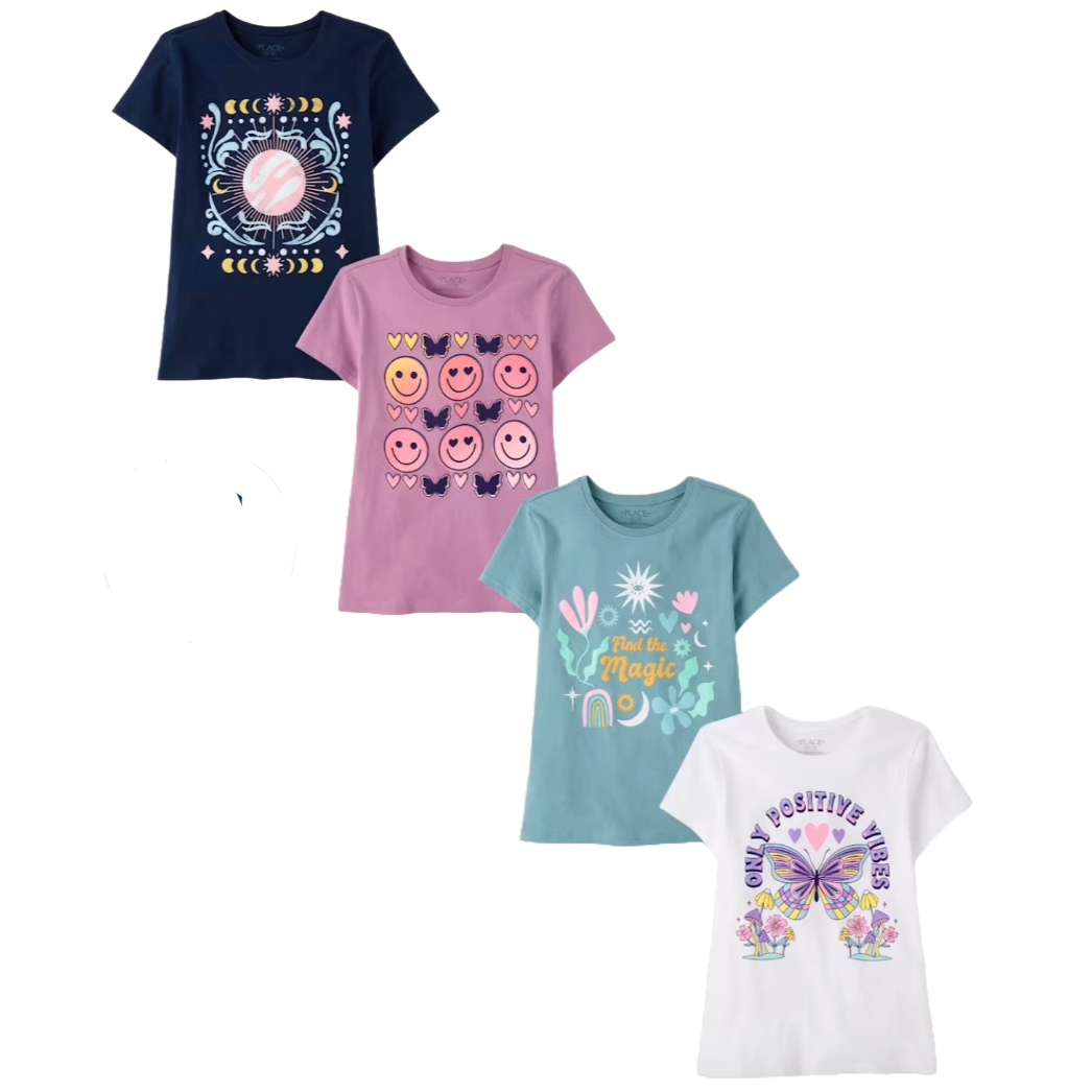 Four girls' graphic T-shirts in different colors: navy with celestial design, pink with smiley faces, teal with \“Find the Magic\“ text, and white with a butterfly and \“Only Positive Vibes.\“