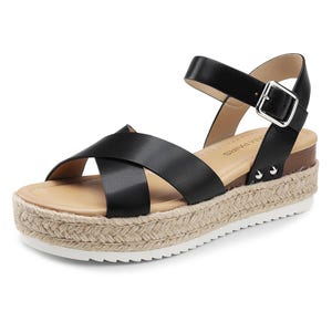 Black espadrille wedge sandals featuring crisscross straps, an adjustable ankle buckle, and a woven jute platform sole with a white rubber tread.