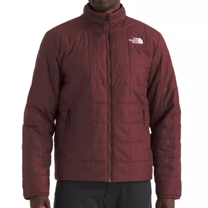 A maroon North Face jacket with a quilted design, featuring a front zipper and two zippered side pockets.