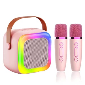 A pink mini karaoke set features a portable speaker with a rainbow LED-lit front grill and leather handle, paired with two pink wireless microphones.
