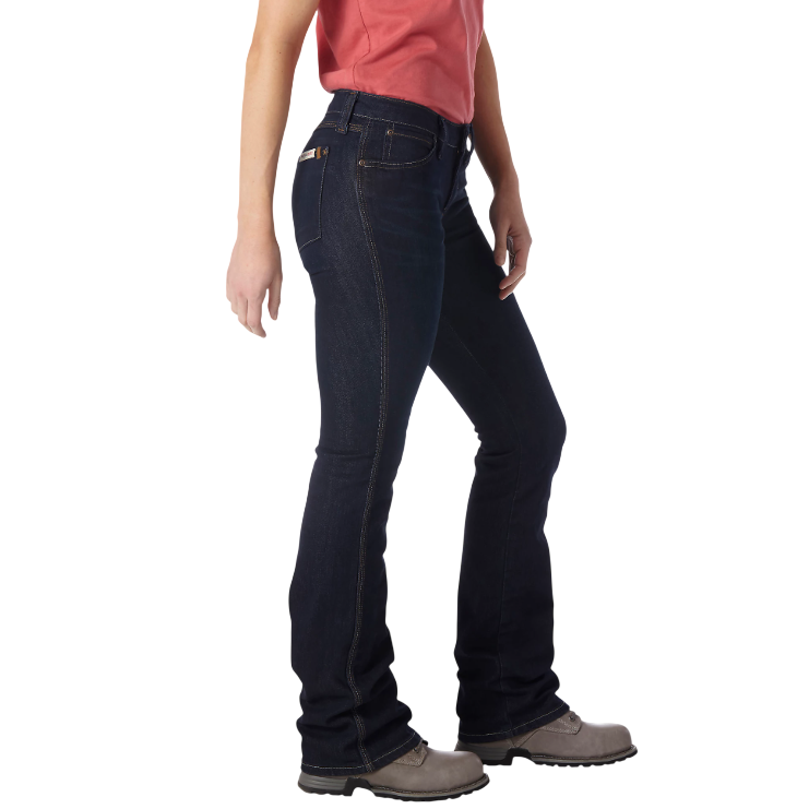 A person is wearing dark blue bootcut jeans paired with grey lace-up shoes and a red top.