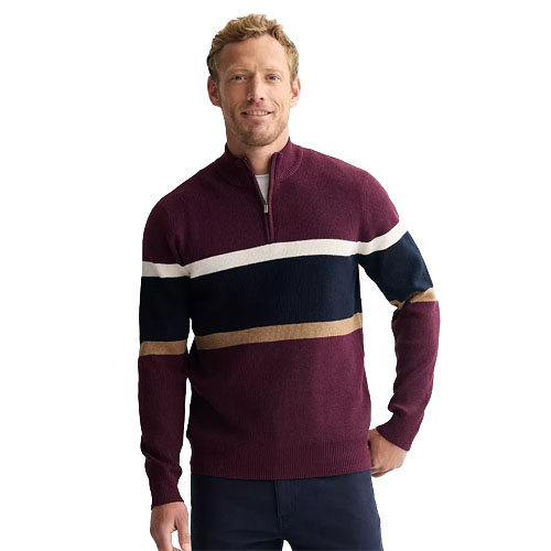 A man wears a maroon quarter-zip sweater featuring horizontal stripes in white, navy, and tan, paired with dark pants.