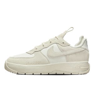 Nike Air Force 1 Wild shoes feature a low-top design with an off-white suede and fabric upper, a prominent Swoosh, and a thick rubber sole for a classic and clean look.