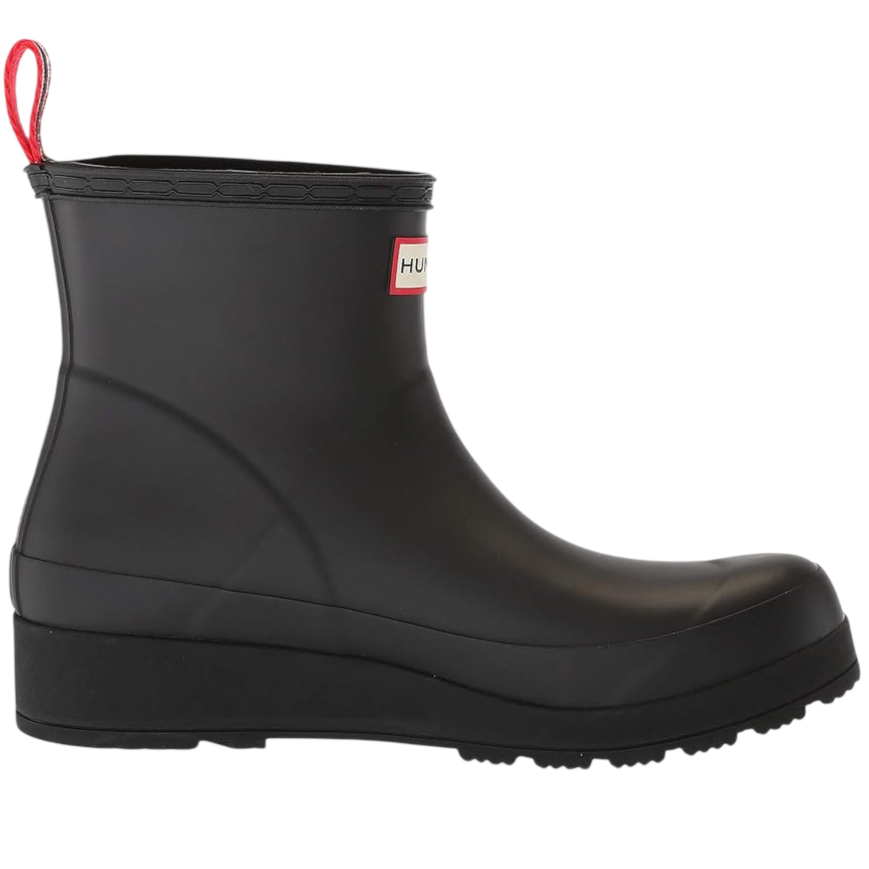 A black ankle-high rubber boot with a wedge heel and a red pull tab. It features a brand label on the side.