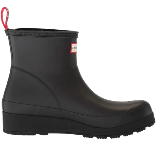 A black ankle-high rubber boot with a wedge heel and a red pull tab. It features a brand label on the side.