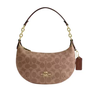 Coach bag with a curved silhouette, featuring a brown monogram pattern, gold hardware, and a leather and chain strap.