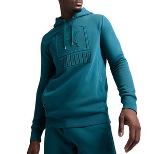 A teal Puma men's hoodie featuring an embossed logo on the chest, with an adjustable drawstring hood and a comfortable fit. Paired with matching sweatpants showing the same logo detail.