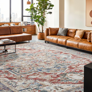 A modern living room features a large patterned rug with blue, red, and beige tones, two brown leather sofas, a tall potted plant, and abstract wall art. A cityscape view is visible through large windows.
