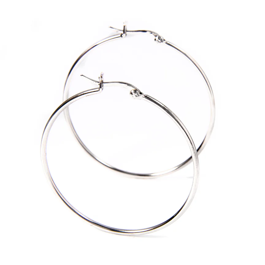 A pair of simple, silver hoop earrings with a thin, circular design and a latch back closure.