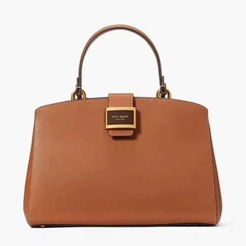 A tan leather Kate Spade handbag with a front flap and top handle.