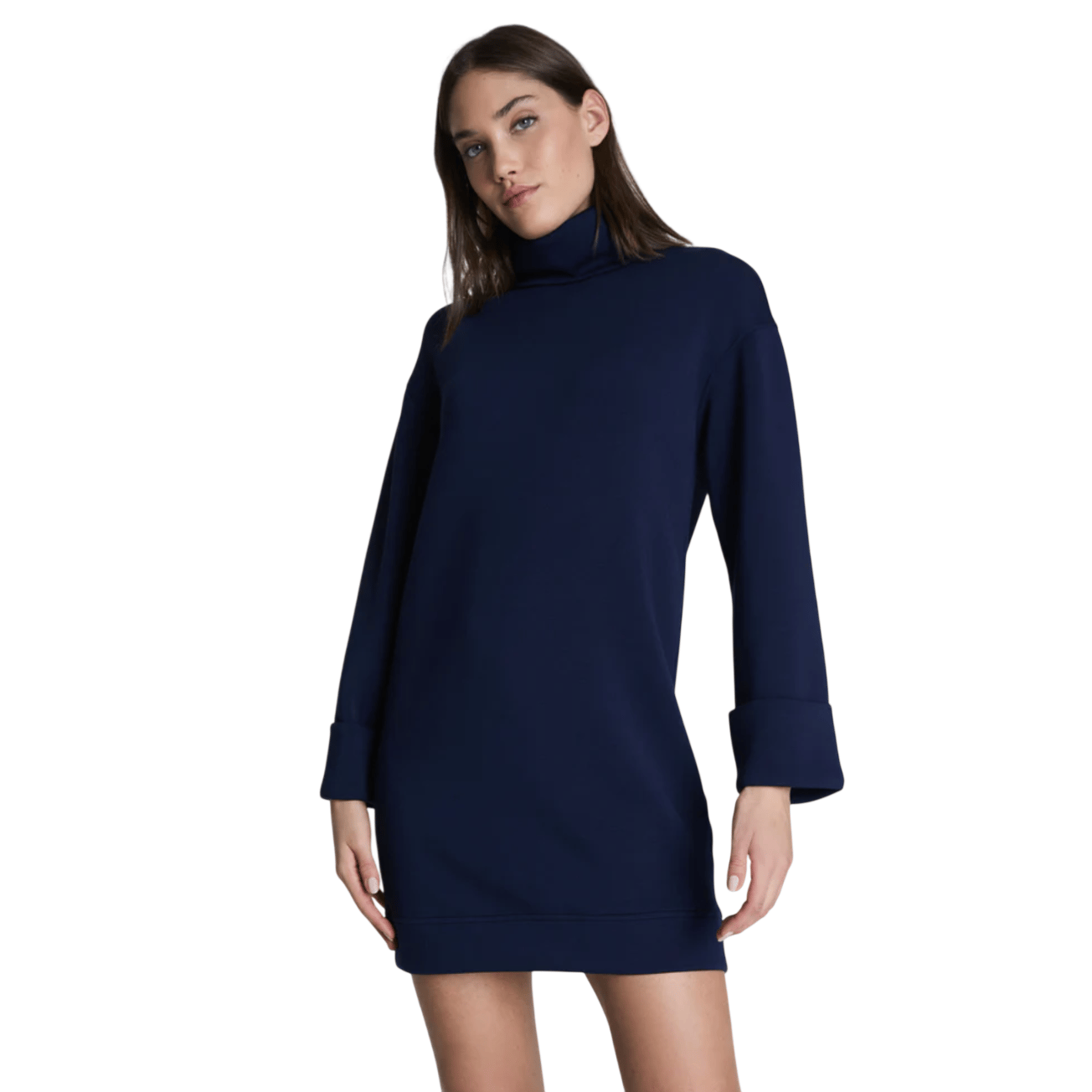 A woman is wearing a navy blue long-sleeve turtleneck dress with cuffed sleeves.
