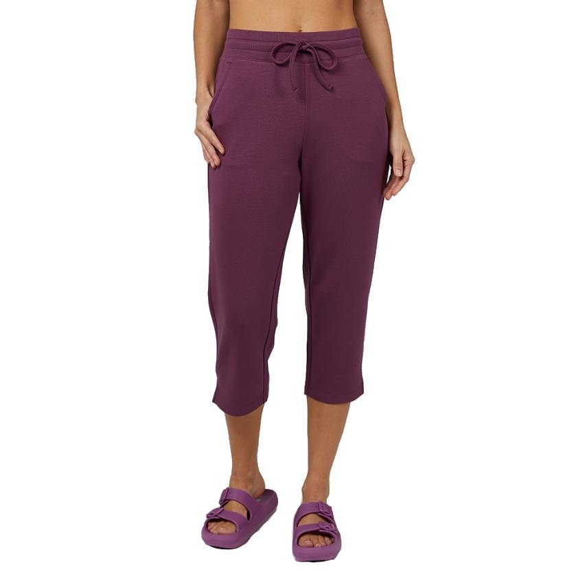 Purple capri pants with a drawstring waistband and side pockets, ending mid-calf, paired with matching sandals.