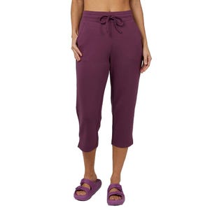 Purple capri pants with a drawstring waistband and side pockets, ending mid-calf, paired with matching sandals.