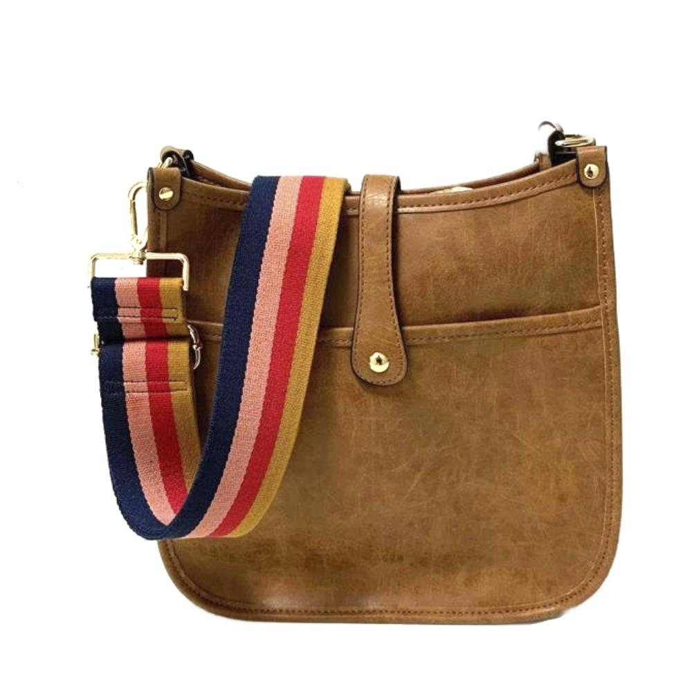 A brown faux-leather courier bag with a front pocket and a flap closure secured by a gold button. It features a colorful, detachable shoulder strap with stripes in navy, red, pink, and mustard.
