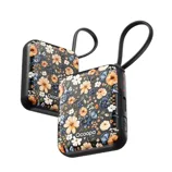 Two portable hand warmers with a floral design and looped handles.