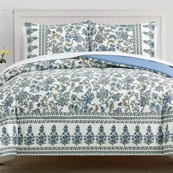 A 3-piece floral comforter set featuring a design of blue and cream-colored flowers with intricate borders. The set includes a comforter and two matching pillow shams, creating a cohesive and elegant look for a bed.