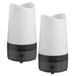 A pair of white and black electric diffusers with a sleek, modern design, featuring a power button on their base.