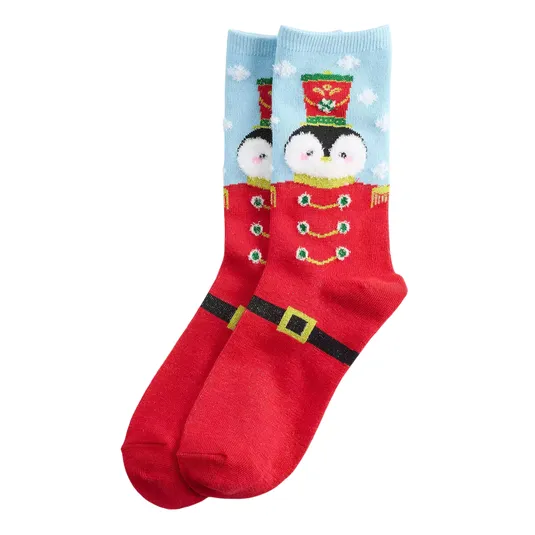 Festive socks featuring a penguin wearing a Nutcracker-style outfit with red and blue colors and holiday-themed details.