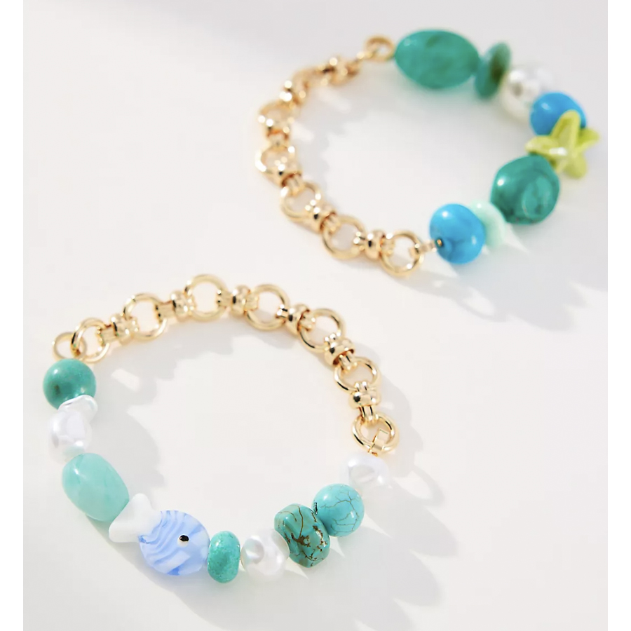 Two bracelets featuring gold chain links and turquoise beads. One includes a small blue fish-shaped charm.
