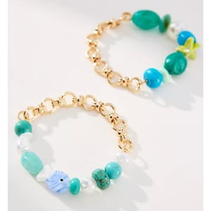 Two bracelets featuring gold chain links and turquoise beads. One includes a small blue fish-shaped charm.