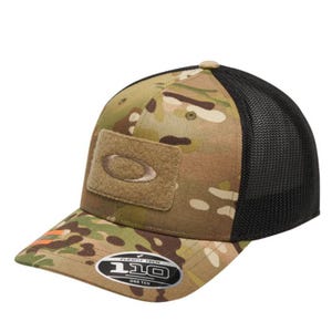Camo-patterned Oakley cap featuring a mesh back, Velcro patch with Oakley logo on the front, and Flexfit 110 technology for adjustable fit.