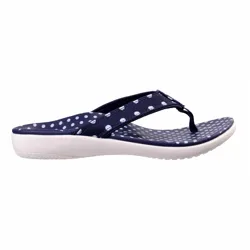 Navy blue flip-flop with white polka dots on the strap and footbed, featuring a cushioned white sole.