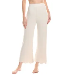 White knit pants with a ribbed texture, featuring a high waist and scalloped hems, worn by a person.