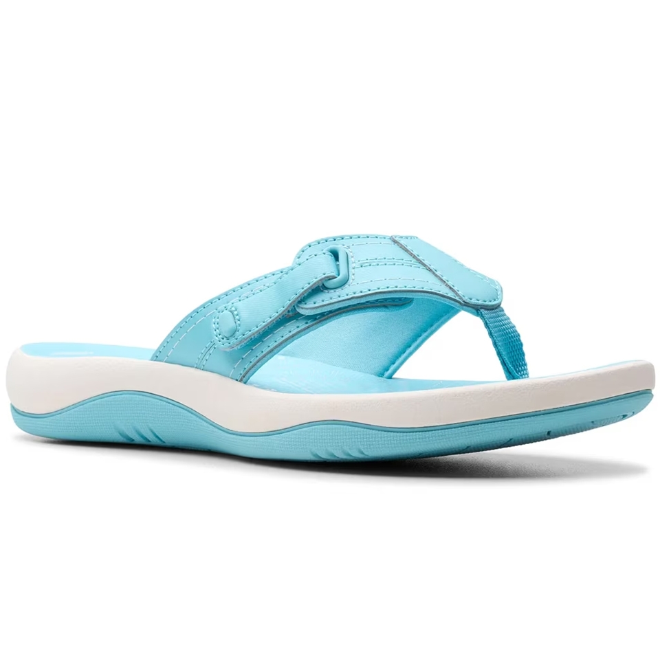 Light blue sandal with a simple thong design, featuring a strap with stitch detailing and a white contoured footbed for comfort.
