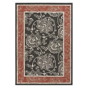 A 5' x 7' area rug featuring a floral pattern with intricate white designs on a black center, bordered by a reddish-brown band with a similar floral motif. Suitable for indoor and outdoor use.