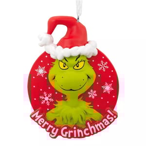 A festive ornament featuring a green character with a Santa hat, set against a red background with snowflakes, and the phrase \“Merry Grinchmas!\“