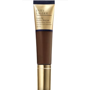 Estee Lauder Futurist Hydra Rescue Moisturizing Makeup with SPF 45 is a hydrating foundation designed for skin protection and coverage. It comes in a tube with a gold and navy design.