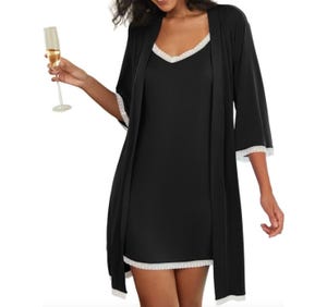 A black nightgown and robe set with white lace trim on the neckline, sleeves, and hem. The robe has three-quarter sleeves, and the nightgown is sleeveless, offering a simple and elegant look.