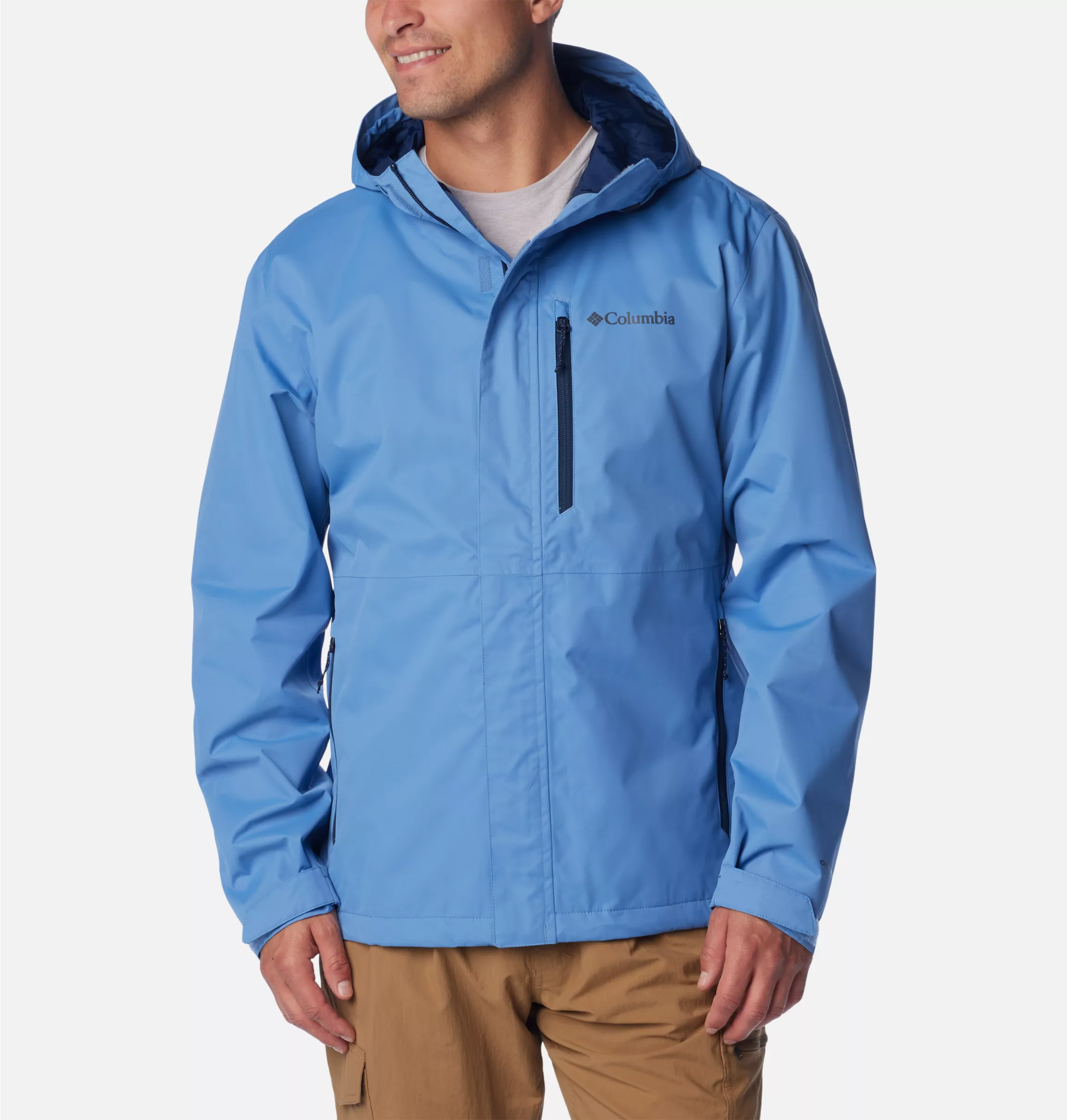 A man wearing a blue Columbia rain jacket with a zipper and hood.