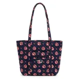 A navy quilted tote bag with a floral pattern and New England Patriots logo, featuring a front zippered pocket and long handles.
