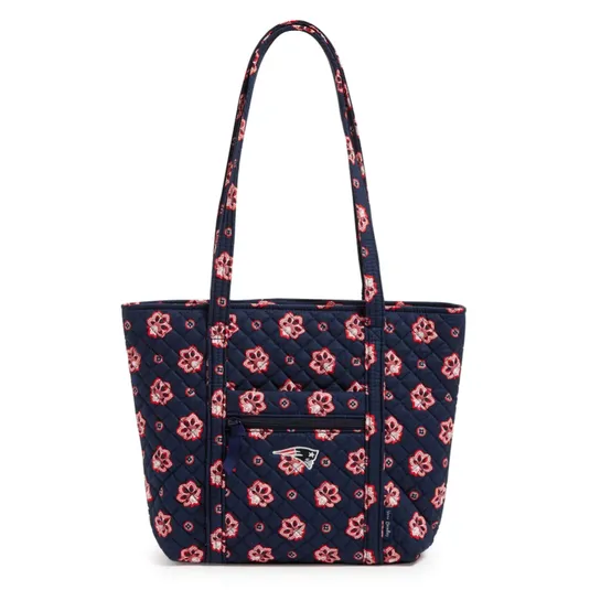 A navy quilted tote bag with a floral pattern and New England Patriots logo, featuring a front zippered pocket and long handles.