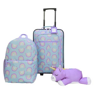 A set of luggage featuring a colorful rainbow pattern, including a backpack, a rolling suitcase, and a purple plush unicorn pillow.