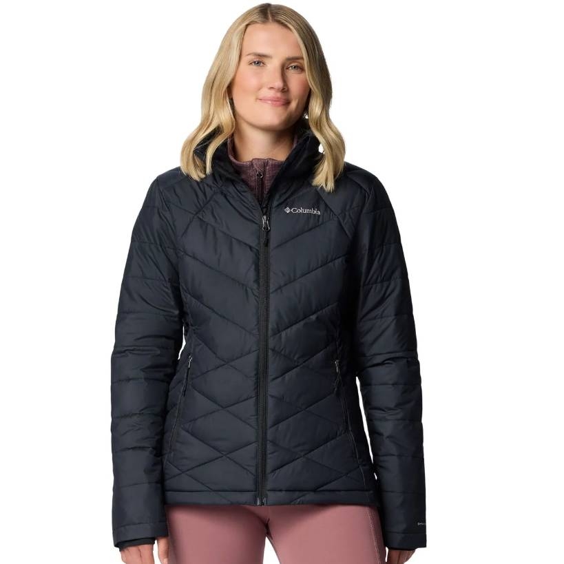 Woman wearing a Columbia black quilted jacket with a front zipper and high collar.