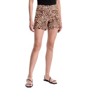 A woman is wearing leopard-print shorts and black sandals with a black sleeveless top.