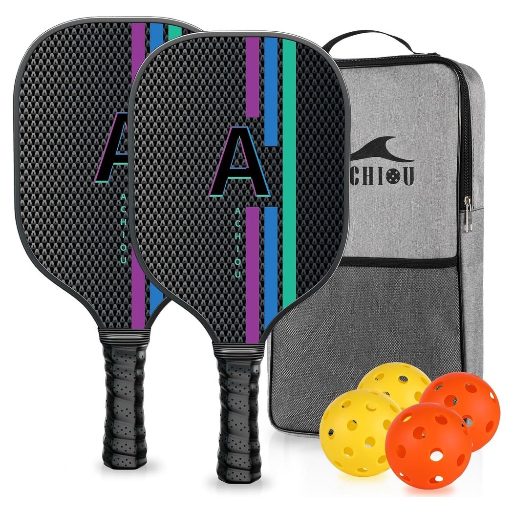 Two pickleball paddles with a geometric pattern and colorful stripes, accompanied by a carrying case and four perforated balls—two orange and two yellow.