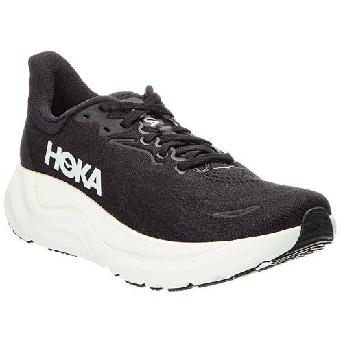 A black HOKA running shoe with a white sole, featuring the brand logo on the side and a mesh upper for breathability.